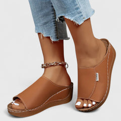 White Celestria™ orthopedic sandals by THE WHITMORE FAMILY, featuring supportive straps and cushioned soles for comfort.