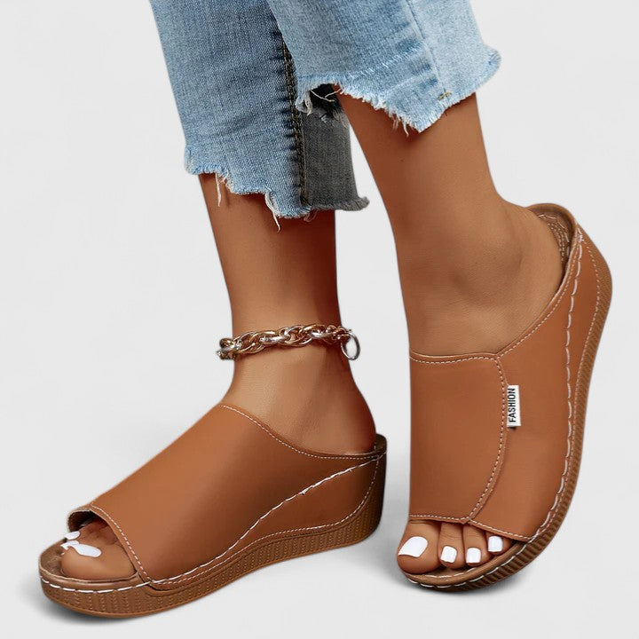 White Celestria™ orthopedic sandals by THE WHITMORE FAMILY, featuring supportive straps and cushioned soles for comfort.