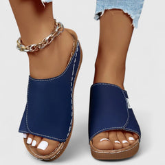 White Celestria™ orthopedic sandals by THE WHITMORE FAMILY, featuring supportive design and comfortable straps.