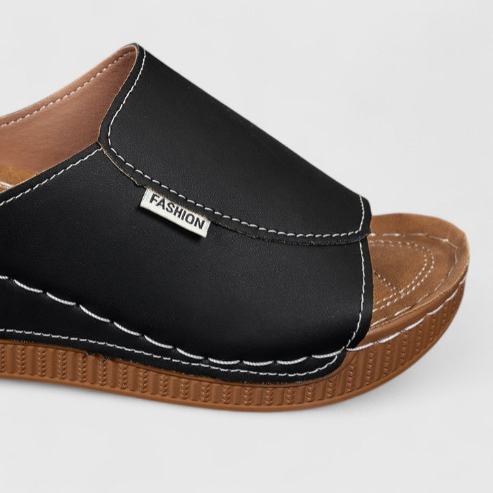 White Celestria™ orthopedic sandals by THE WHITMORE FAMILY featuring supportive straps and cushioned soles for comfort.