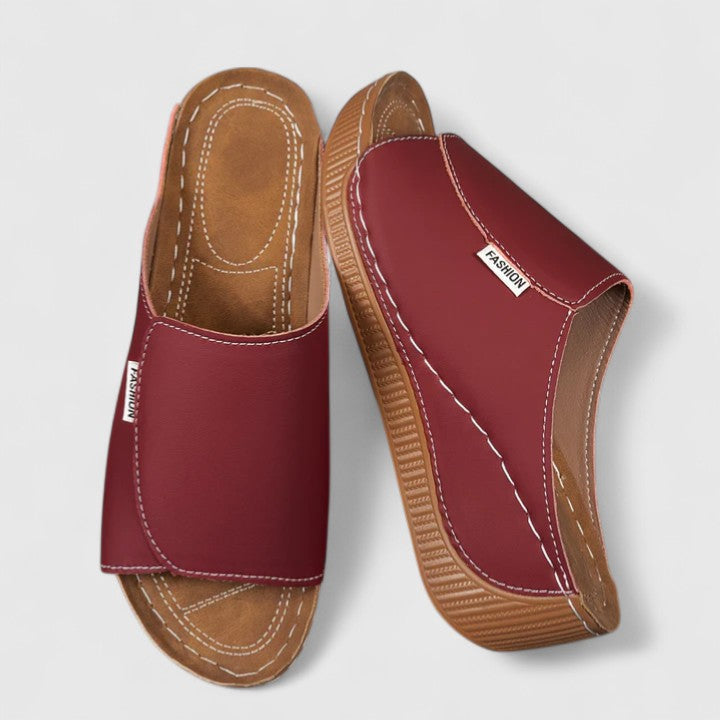 White Celestria™ orthopedic sandals by THE WHITMORE FAMILY with cushioned straps and supportive soles for comfort.