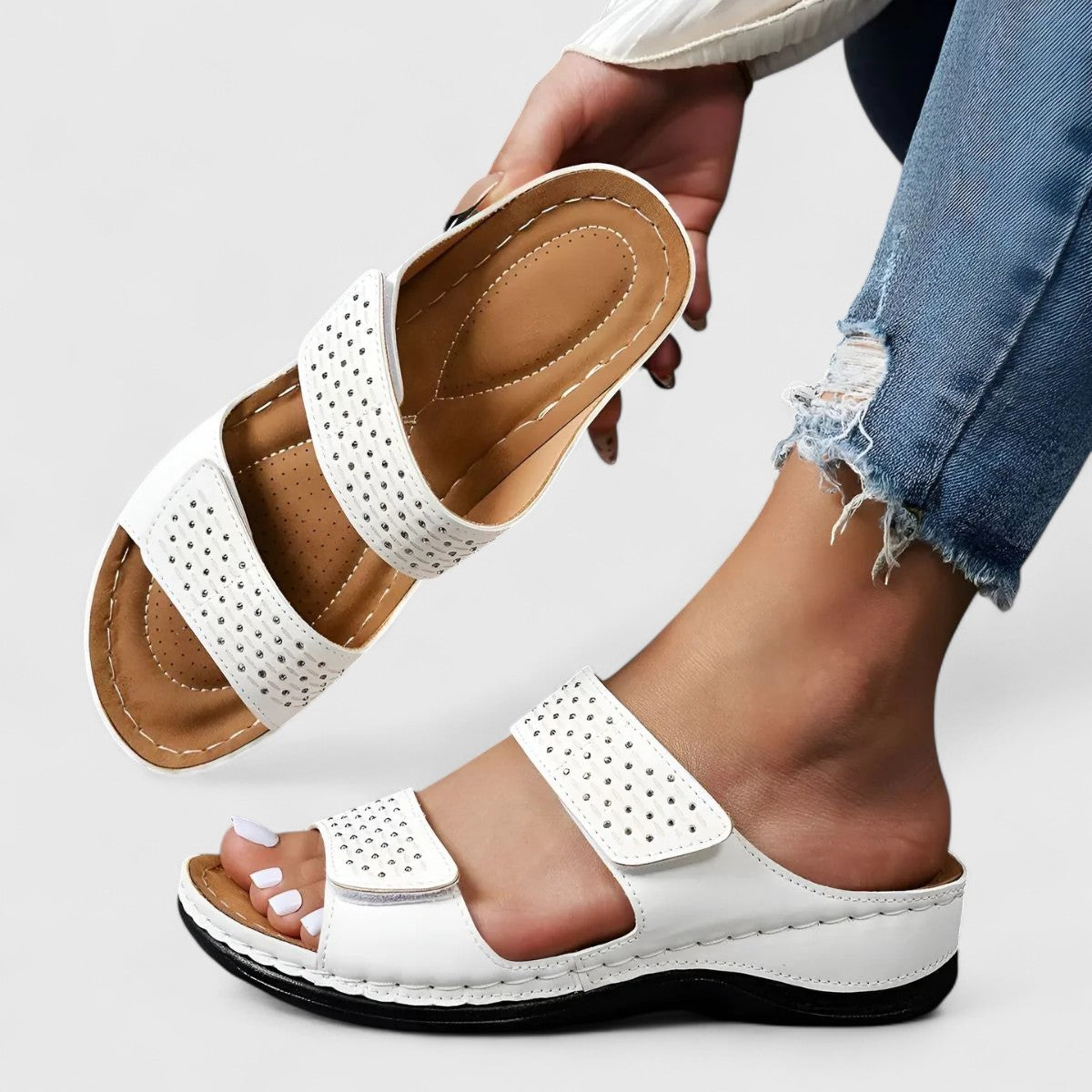 White Karyssa™ orthopedic sandals by THE WHITMORE FAMILY, featuring cushioned straps and supportive sole for comfort.