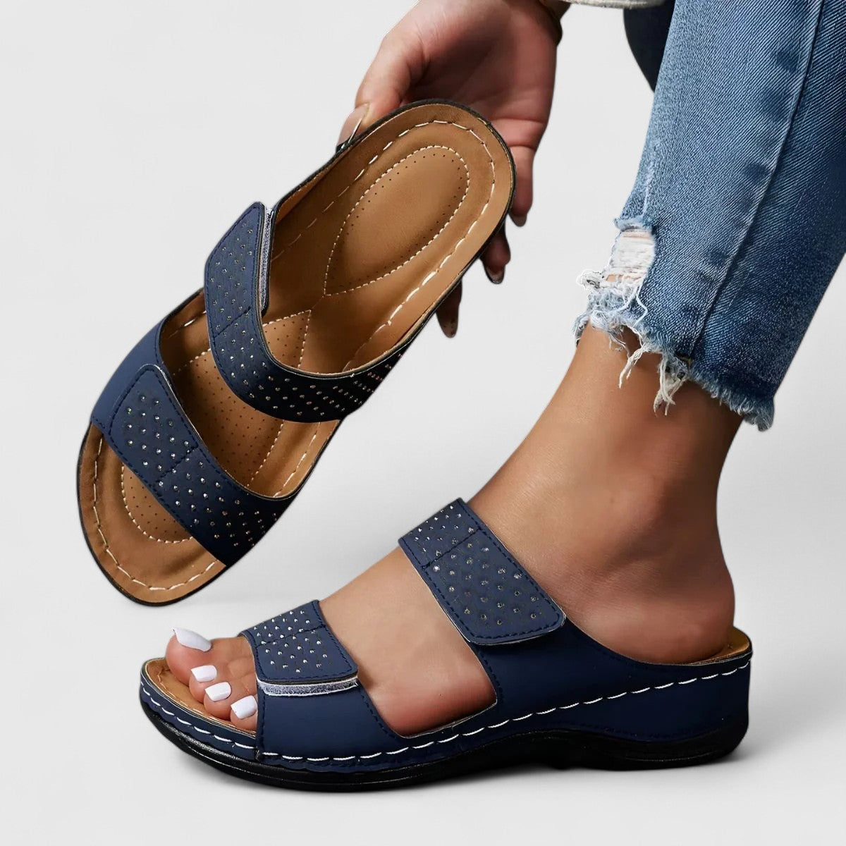 White Karyssa™ orthopedic sandals by THE WHITMORE FAMILY, featuring supportive straps and cushioned soles for comfort.
