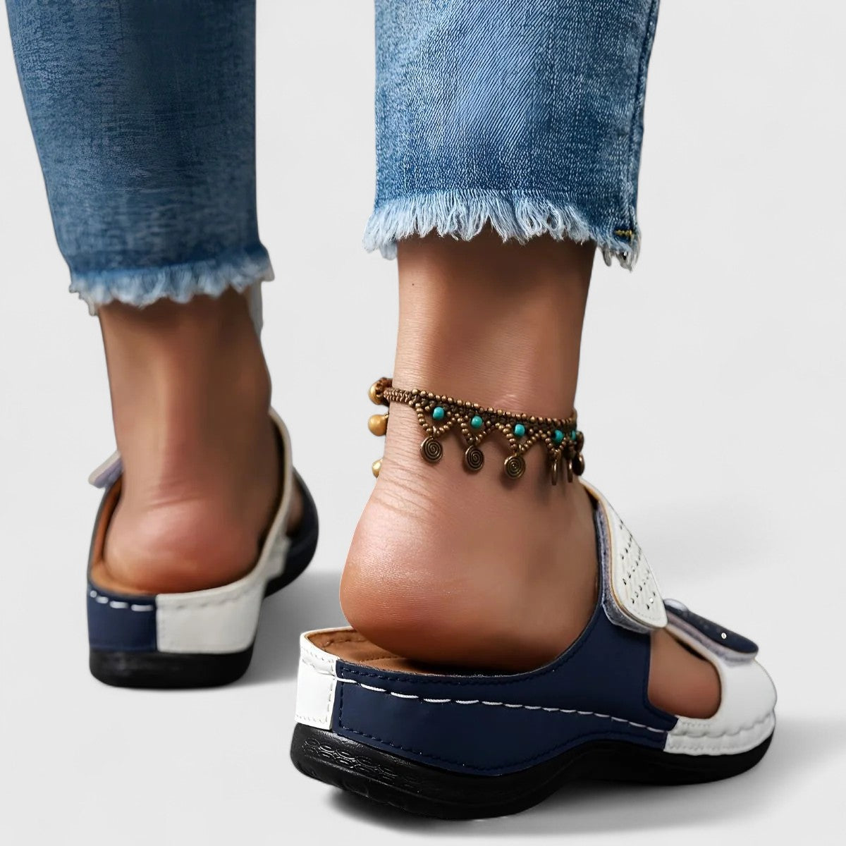 White Karyssa™ Orthopedic Sandals by THE WHITMORE FAMILY with cushioned soles and supportive straps, designed for comfort.