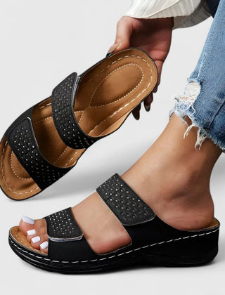 White Karyssa™ orthopedic sandals by THE WHITMORE FAMILY with cushioned soles and adjustable straps, designed for comfort and support.