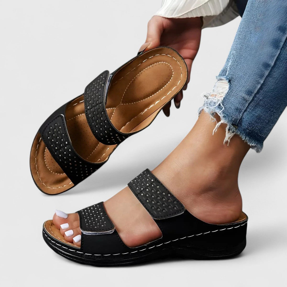 White Karyssa™ orthopedic sandals by THE WHITMORE FAMILY with cushioned soles and adjustable straps, designed for comfort and support.