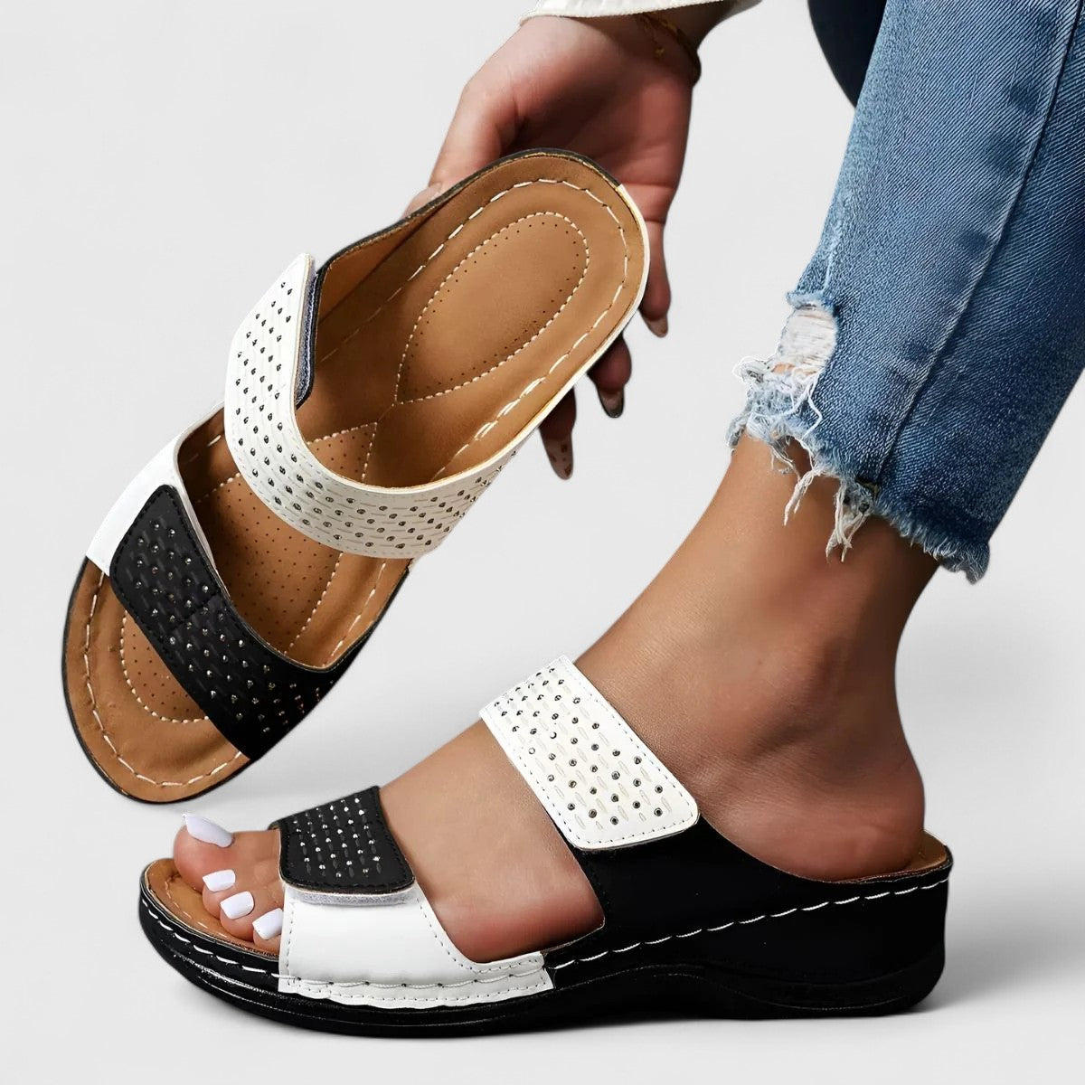 White Karyssa™ orthopedic sandals by THE WHITMORE FAMILY with cushioned straps and supportive soles, designed for comfort and style.