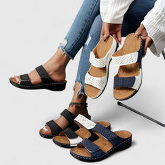 White Karyssa™ orthopedic sandals by THE WHITMORE FAMILY with cushioned straps and supportive soles.