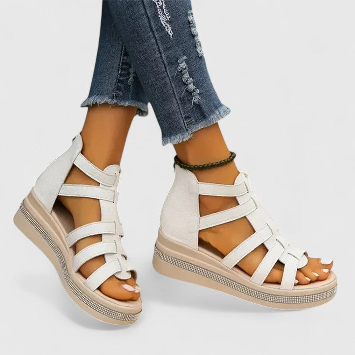 White Kendall™ orthopedic strass sandals with cushioned soles and decorative straps, designed for comfort and style.