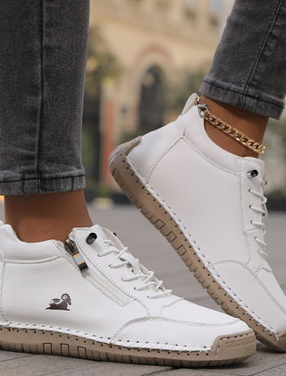 White Maïa™ ergonomic support sneakers by THE WHITMORE FAMILY, featuring cushioned soles and breathable design.