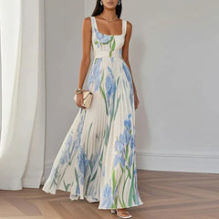 White and blue floral A-line maxi dress from THE WHITMORE FAMILY's Grace collection, featuring a flowing, elegant design.