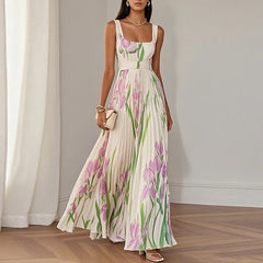 Grace floral A-line maxi dress by THE WHITMORE FAMILY featuring white and blue floral fabric, flowing silhouette, and elegant design.