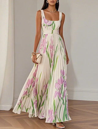 Grace floral A-line maxi dress by THE WHITMORE FAMILY featuring white and blue floral fabric, flowing silhouette, and elegant design.