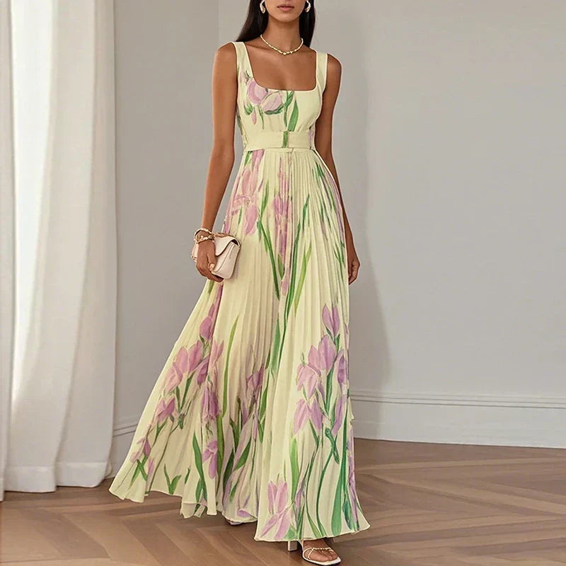 Grace floral A-line maxi dress by THE WHITMORE FAMILY featuring white and blue fabric, flowing style, and elegant design.