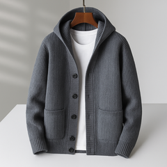 White Ramsay™ Modern Cardigan by THE WHITMORE FAMILY displayed on a hanger, showcasing its sleek design and soft fabric.