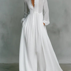 White Barbara flowy button-front maxi dress by THE WHITMORE FAMILY, with lightweight fabric and elegant, flowing silhouette.