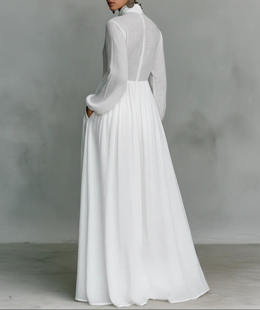 White Barbara maxi dress by THE WHITMORE FAMILY featuring a flowing fabric and button-front design.