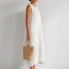 Casual sleeveless dress by THE WHITMORE FAMILY in white, featuring a relaxed fit and simple style for everyday wear.