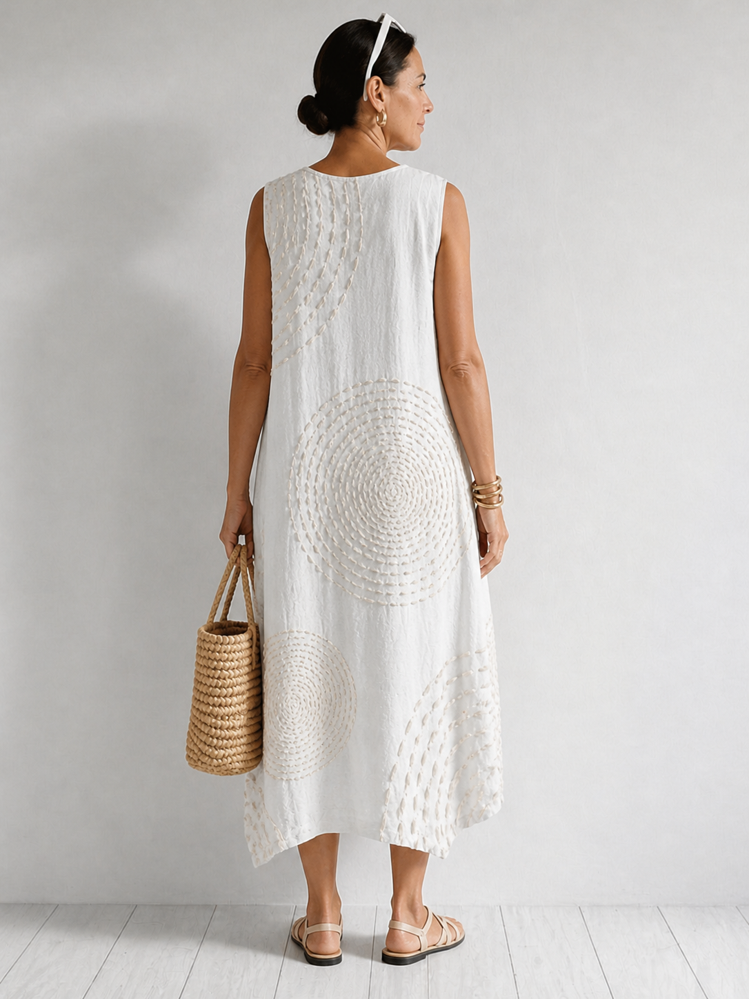 White Oplena casual sleeveless dress by THE WHITMORE FAMILY, featuring a relaxed fit and simple, elegant design for warm weather.
