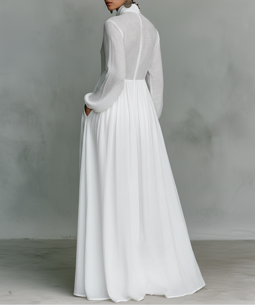 White Serena maxi dress by THE WHITMORE FAMILY featuring a flowing silhouette and button-front design.