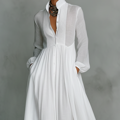 White Serena maxi dress by THE WHITMORE FAMILY featuring a flowing design and button-front detail, perfect for elegant casual wear.