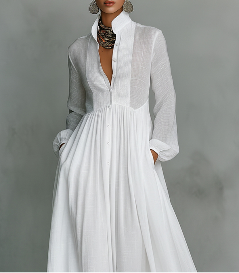 White Serena maxi dress by THE WHITMORE FAMILY featuring a flowing design and button-front detail, perfect for elegant casual wear.