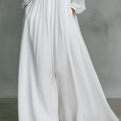 White Serena flowing maxi dress by THE WHITMORE FAMILY with button-front design, lightweight and elegant for summer wear.