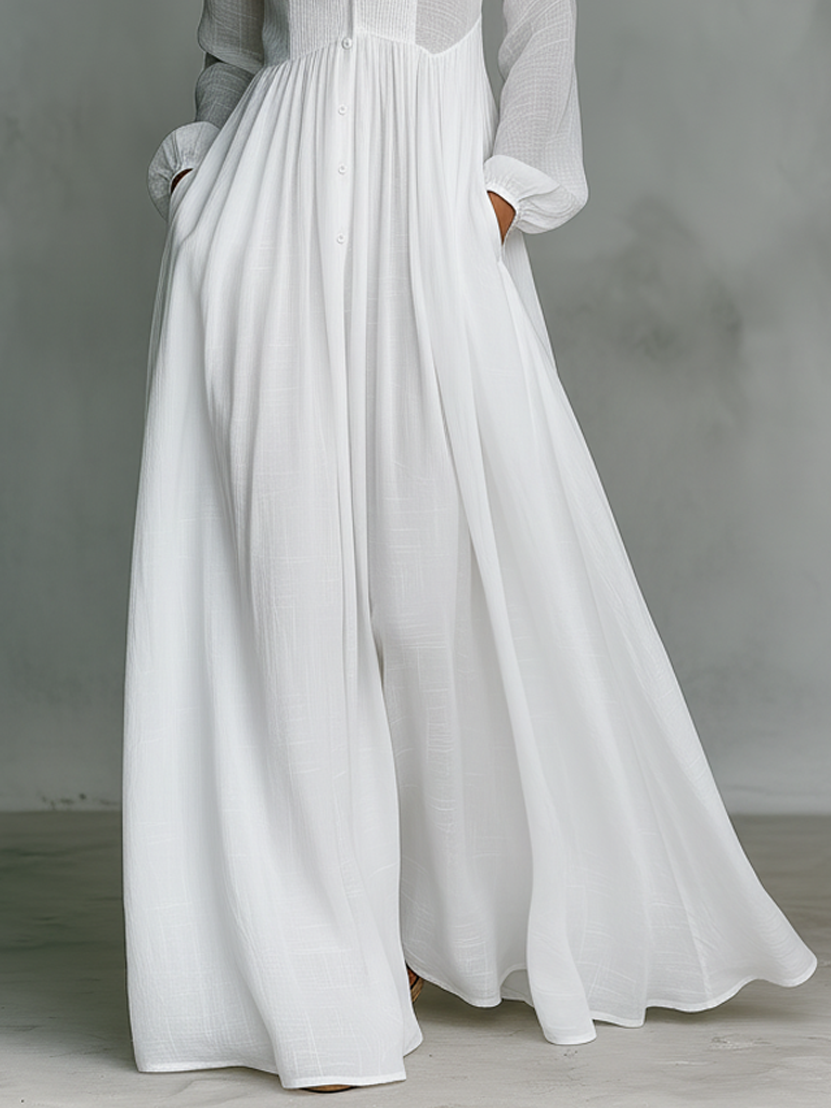 White Serena flowing maxi dress by THE WHITMORE FAMILY with button-front design, lightweight and elegant for summer wear.