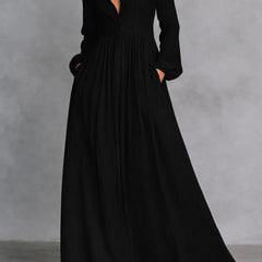 White Serena maxi dress by THE WHITMORE FAMILY featuring flowing fabric and a button-front design, displayed on a hanger.