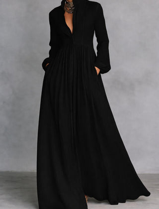 White Serena maxi dress by THE WHITMORE FAMILY featuring flowing fabric and a button-front design, displayed on a hanger.