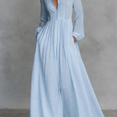 White Serena maxi dress by THE WHITMORE FAMILY, flowing fabric with button-front design, full-length dress on a model.