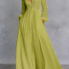 White Serena maxi dress by THE WHITMORE FAMILY featuring a flowing design and button-front closure.