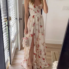 Scarlett romantic floral dress by THE WHITMORE FAMILY displayed on a hanger with a floral pattern and lightweight fabric.