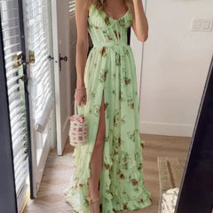 Scarlett Romantic Floral Dress by THE WHITMORE FAMILY, featuring a flowy fabric with a floral print on a white background.