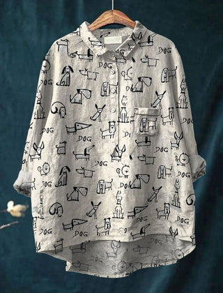 White dog doodle shirt from THE WHITMORE FAMILY featuring a playful design, displayed on a mannequin or laid flat.