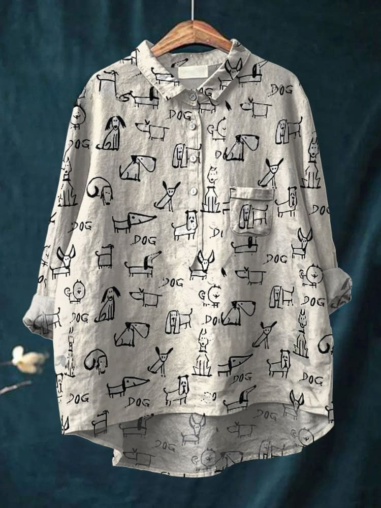 White dog doodle shirt from THE WHITMORE FAMILY featuring a playful design, displayed on a mannequin or laid flat.