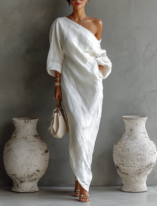 White Nelle™ Elegant Maxi Dress from THE WHITMORE FAMILY, flowing fabric, V-neckline, and sleeveless design on a model.