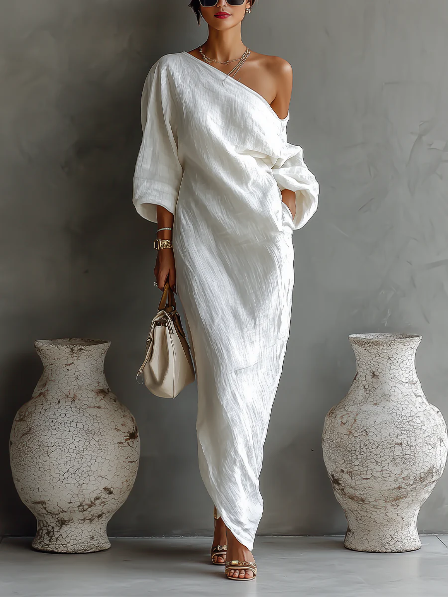 White Nelle™ Elegant Maxi Dress from THE WHITMORE FAMILY, flowing fabric, V-neckline, and sleeveless design on a model.