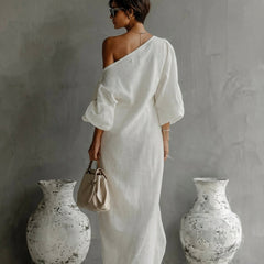 White Nelle™ Elegant Maxi Dress by THE WHITMORE FAMILY featuring flowing fabric and a stylish, feminine silhouette.