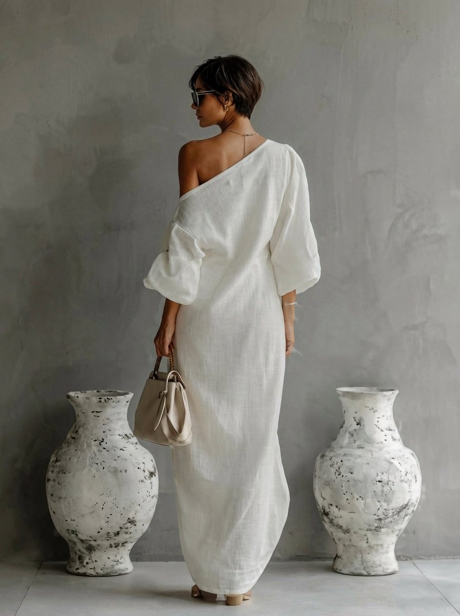 White Nelle™ Elegant Maxi Dress by THE WHITMORE FAMILY featuring flowing fabric and a stylish, feminine silhouette.