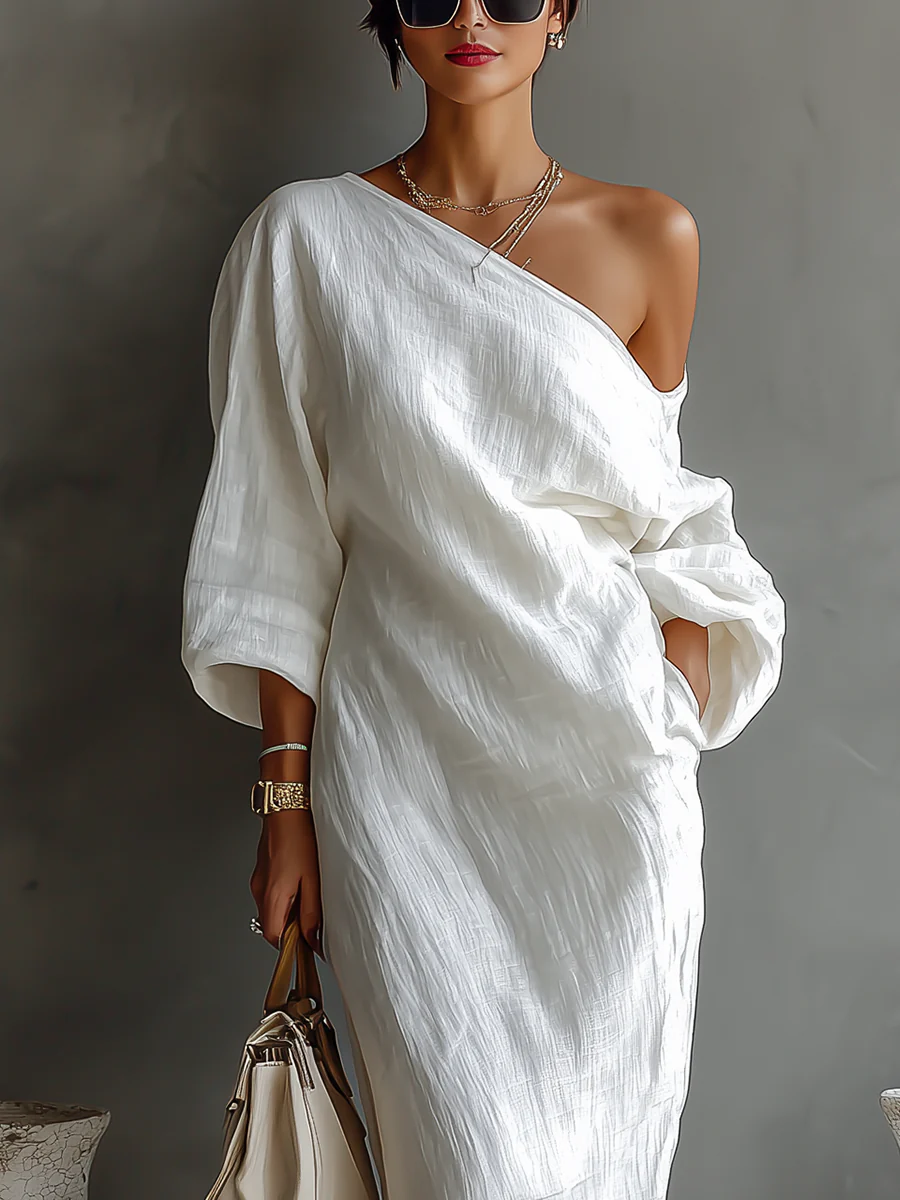 White Nelle™ Elegant Maxi Dress by THE WHITMORE FAMILY, featuring flowing fabric and a sophisticated design, shown on a model.