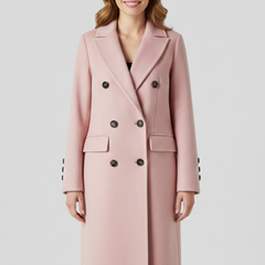 Women’s beige coat by THE WHITMORE FAMILY with lapel collar and button closure, stylish outerwear for cold weather.