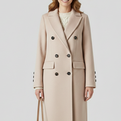 Beige women coat with lapel collar and button closure by THE WHITMORE FAMILY, displayed on a hanger.