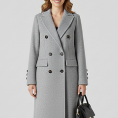 Beige women coat with lapel collar and button closure from THE WHITMORE FAMILY, shown on a model.