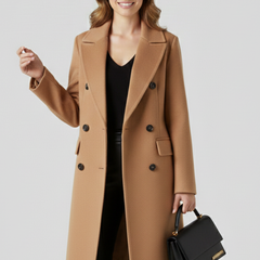 Beige women’s coat with lapel collar and button closure by THE WHITMORE FAMILY, featuring a stylish and tailored design.