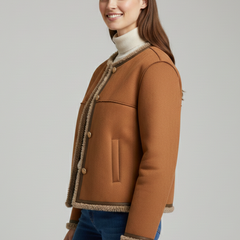 Women’s brown jacket by THE WHITMORE FAMILY with button closure and stylish trim edging.