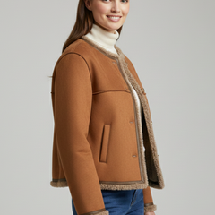 Women’s brown jacket by THE WHITMORE FAMILY with button closure and trim edging, shown on a model.