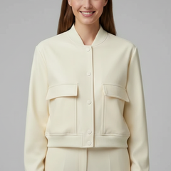 Beige women’s bomber jacket by THE WHITMORE FAMILY featuring a baseball collar and snap buttons, stylish and casual outerwear.