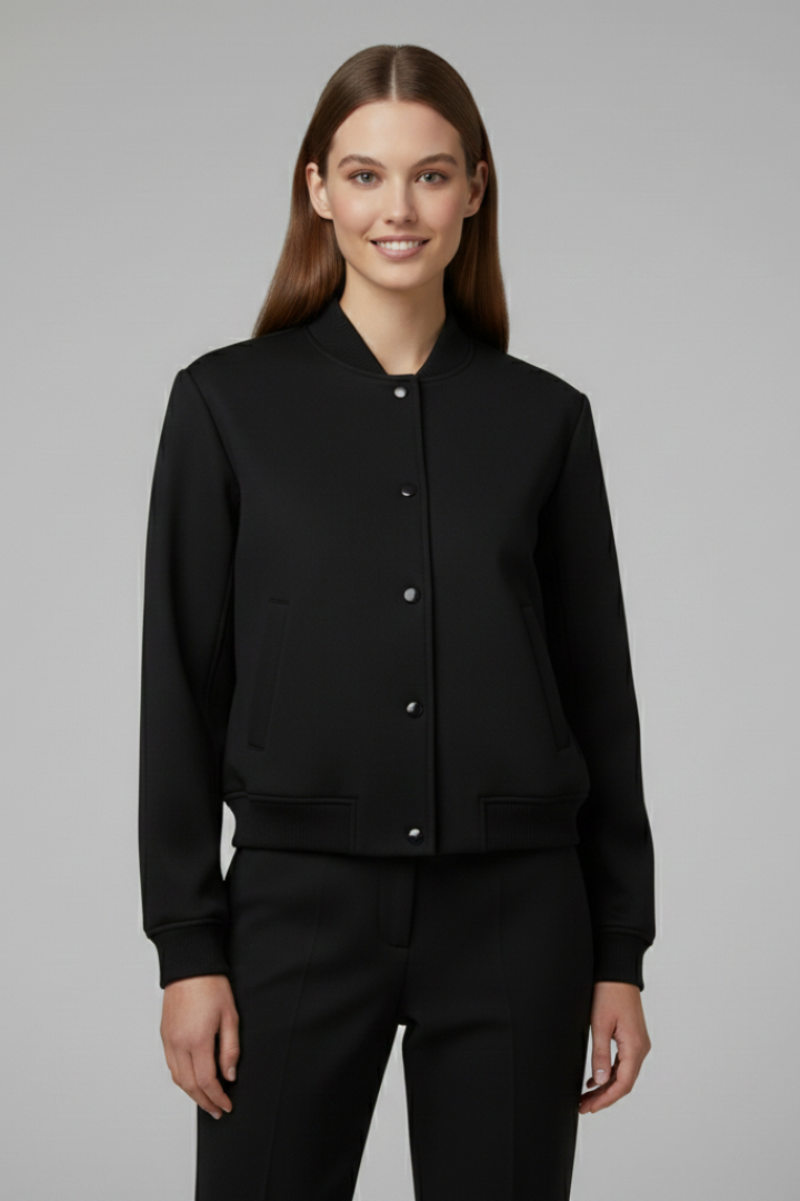 Beige women’s bomber jacket from THE WHITMORE FAMILY featuring a baseball collar and snap buttons, styled for casual wear.