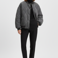 Women's grey bomber jacket by THE WHITMORE FAMILY with snap closure and quilted surface, styled for a casual look.